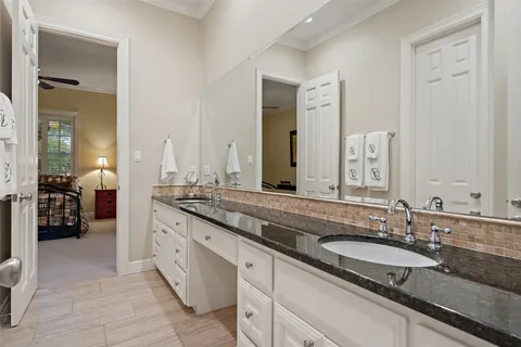a bathroom with sinks granite countertop double vanity and a mirror