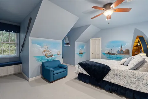 a living room with furniture and a painting on the wall