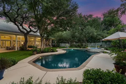 a view of a house with swimming pool and sitting area