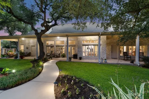 a view of a porch with furniture and garden