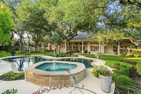 a view of a house with backyard sitting area and swimming pool