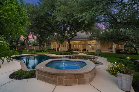 a view of a house with swimming pool and sitting area