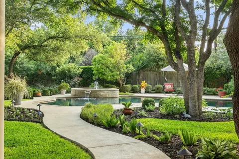 a view of a garden with a bench in the garden