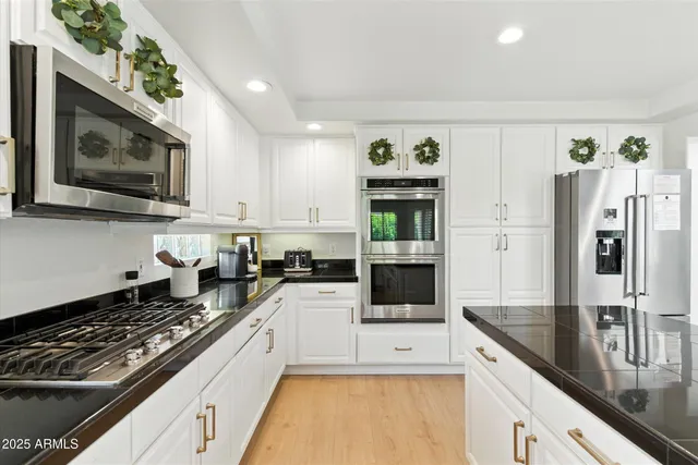 a large kitchen with a stove and a refrigerator