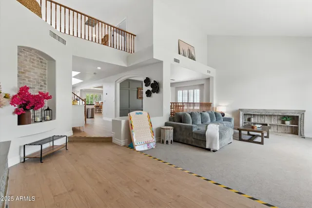 a living room with furniture and flowers