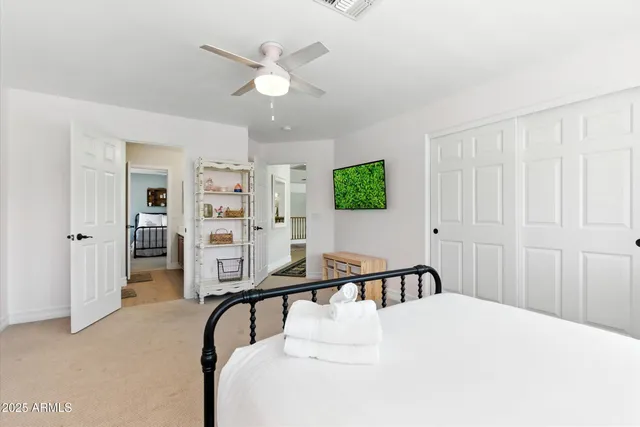 a bedroom with a bed and a desk