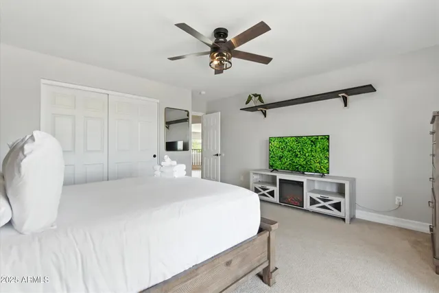 a view of a swimming pool with a table and chairs under an umbrella
