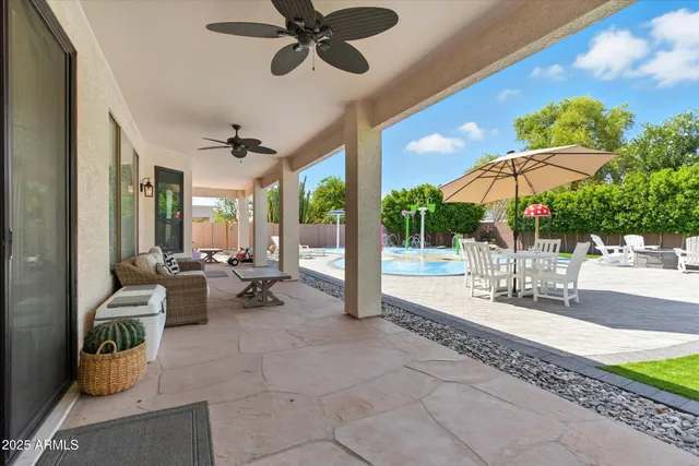 a view of a house with swimming pool and sitting area