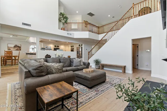 a living room with furniture and wooden floor