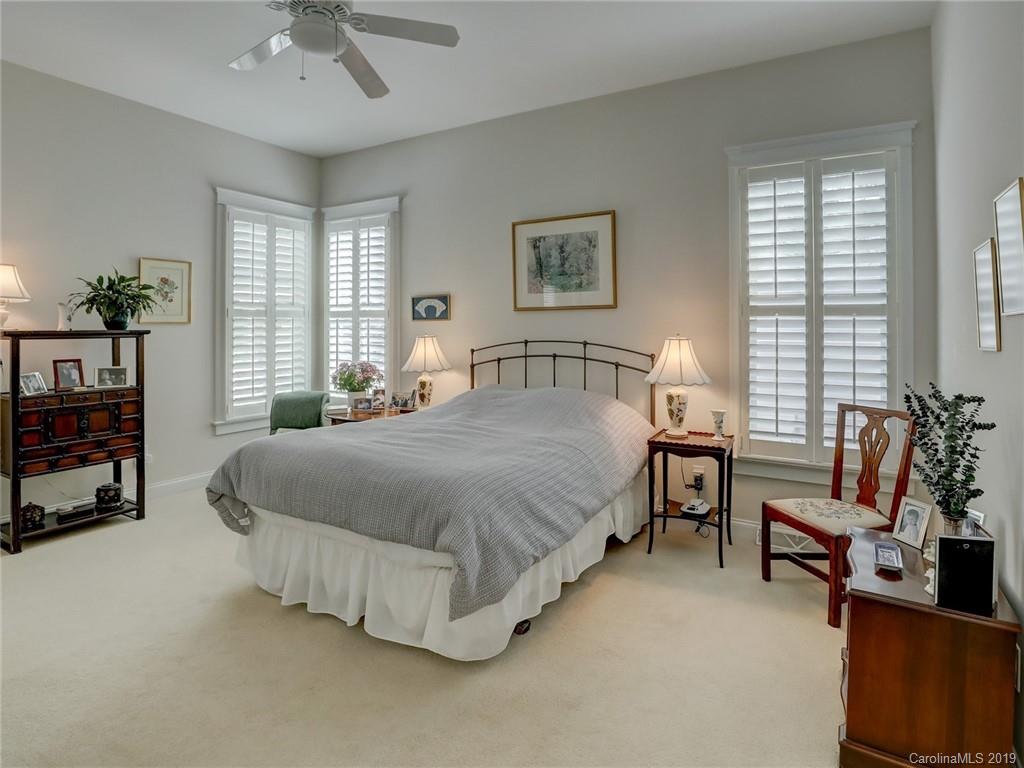761 Shady Grove Crossing Fort Mill, SC 29708 - Photo 17 of 48 a spacious bedroom with a bed and a chandelier