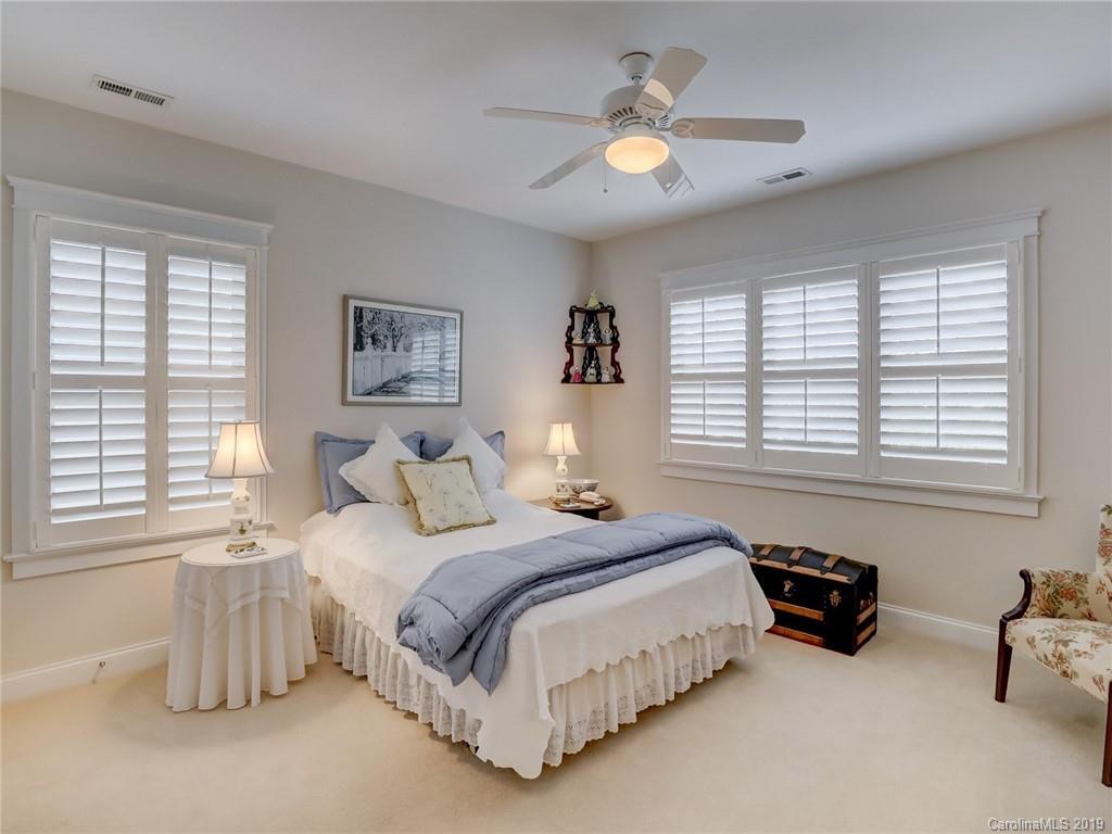 761 Shady Grove Crossing Fort Mill, SC 29708 - Photo 23 of 48 a spacious bedroom with a bed and a couch