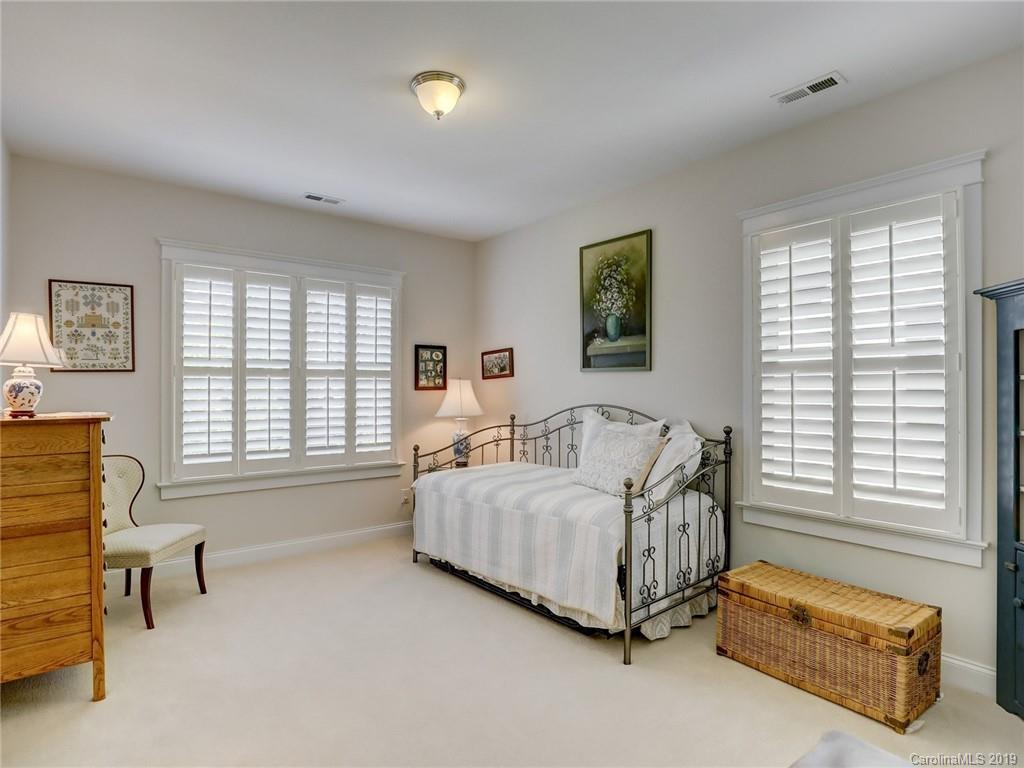 761 Shady Grove Crossing Fort Mill, SC 29708 - Photo 25 of 48 a spacious bedroom with a bed a couch and a window