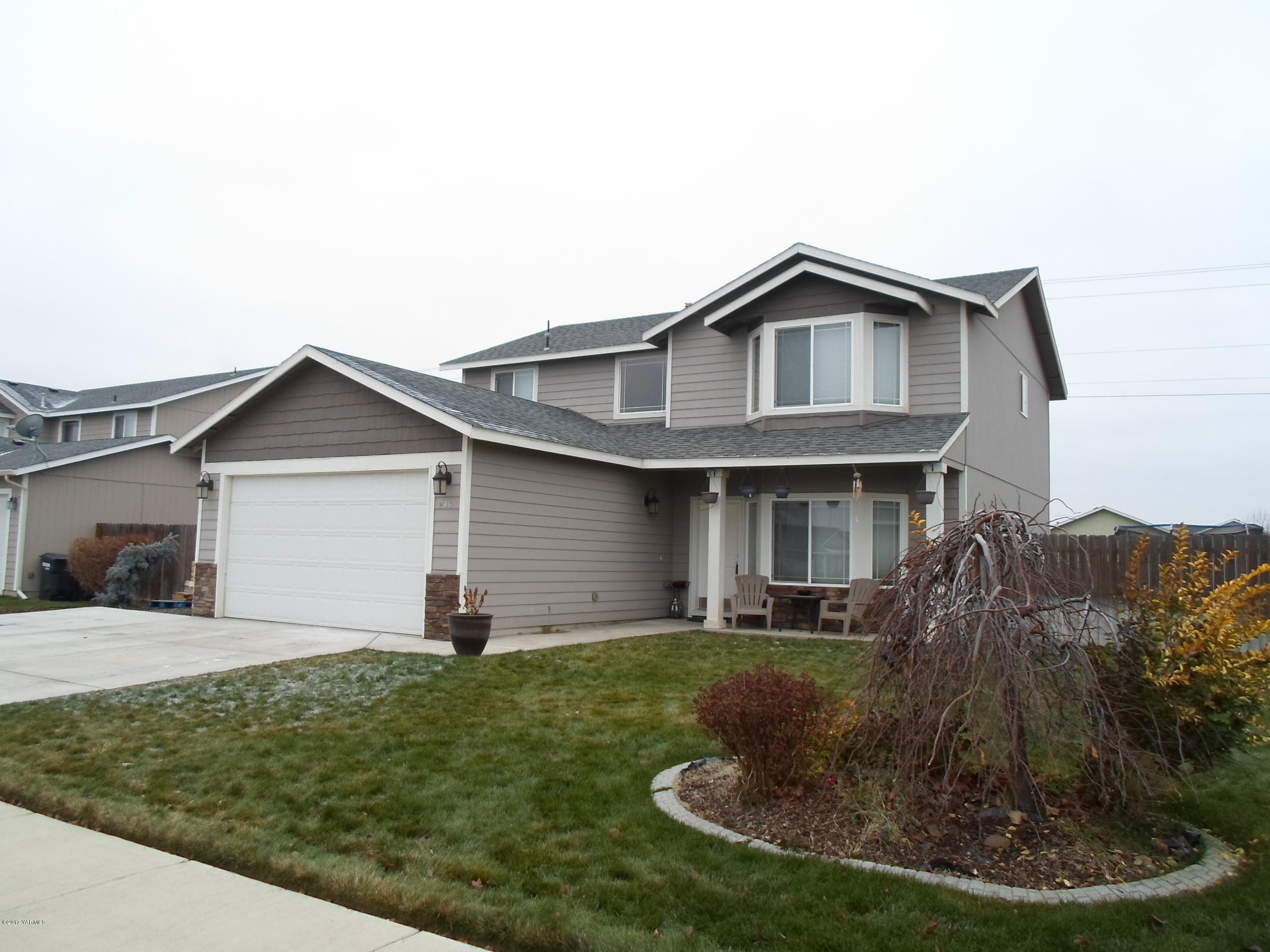 a front view of house with yard and trees
