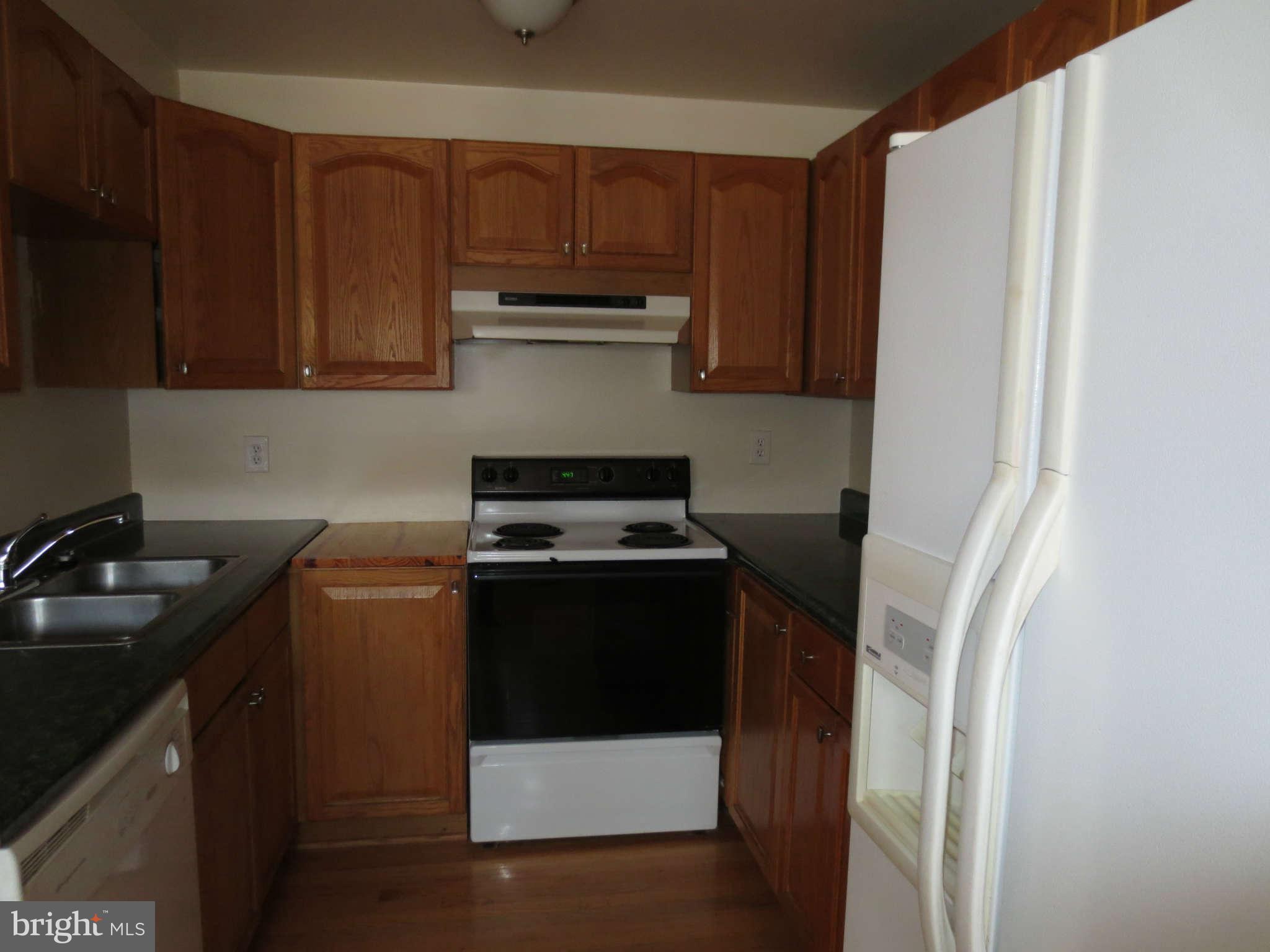 17609 Kohlhoss Road Poolesville, MD 20837 - Photo 2 of 8 a kitchen with a refrigerator and a sink