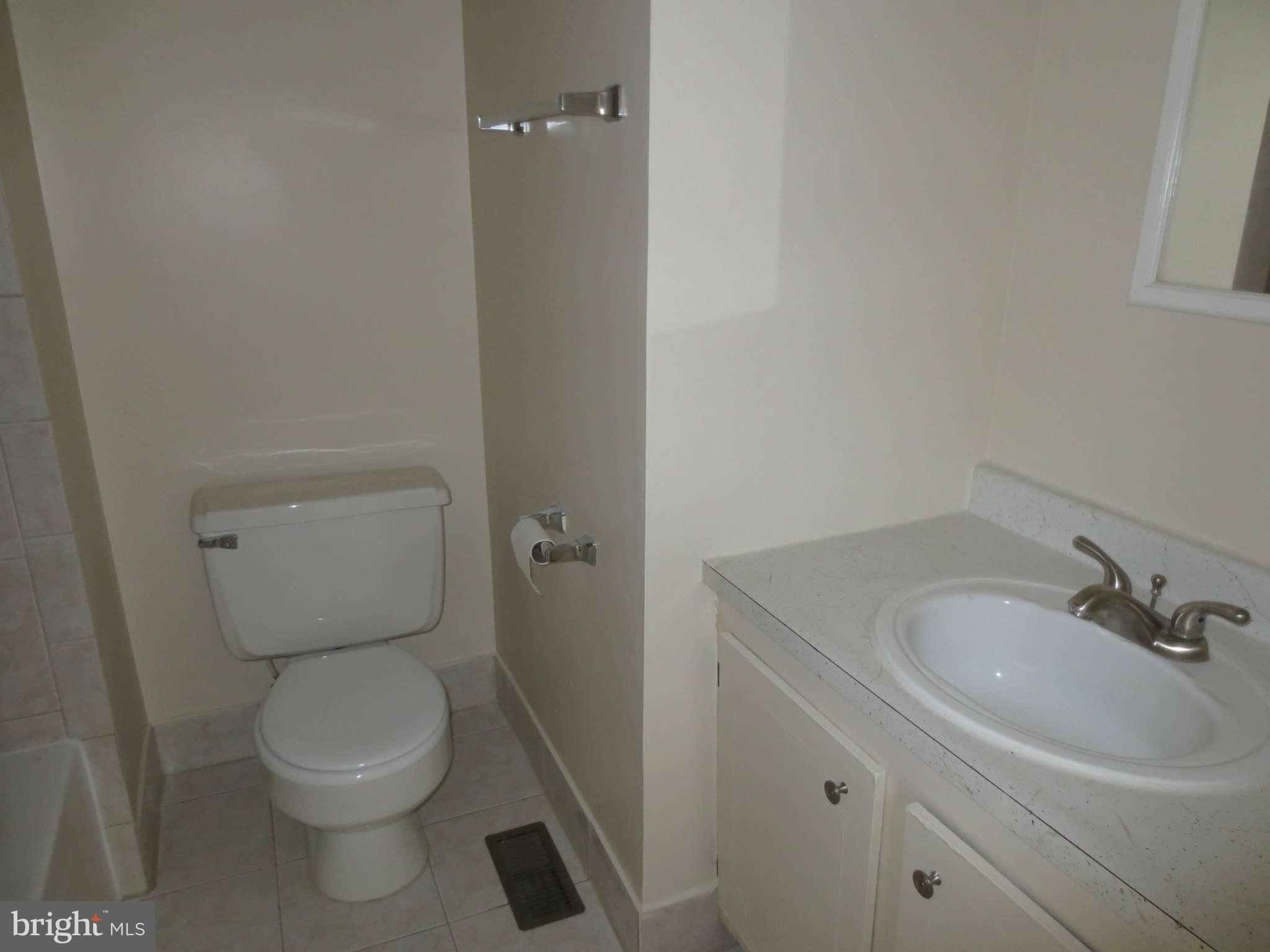 17609 Kohlhoss Road Poolesville, MD 20837 - Photo 7 of 8 a bathroom with a toilet a sink and mirror