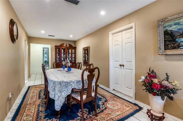 a dining room with furniture and flowers