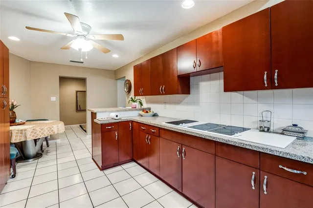 a kitchen with stainless steel appliances granite countertop a sink dishwasher stove and cabinets