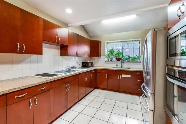 a kitchen with stainless steel appliances granite countertop a sink stove and cabinets