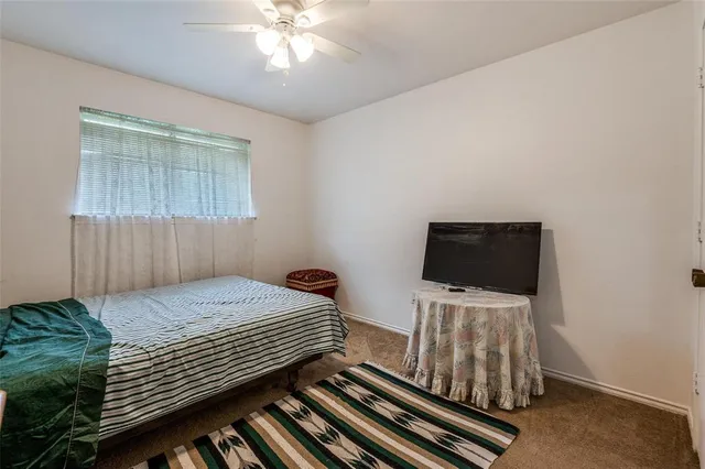 a bedroom with a bed and flat screen tv