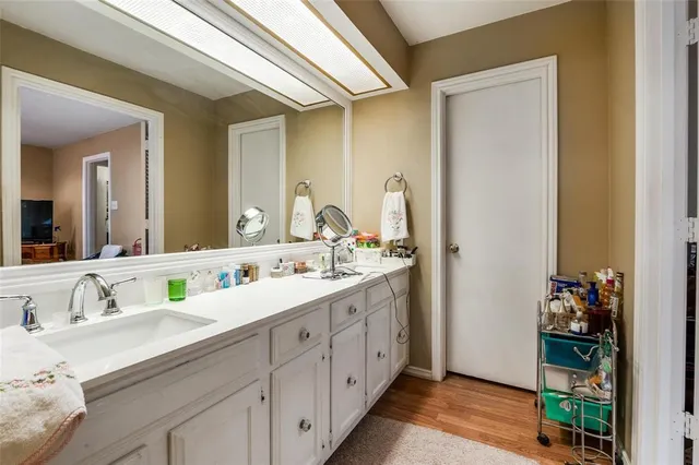 a bathroom with a double vanity sink and a mirror