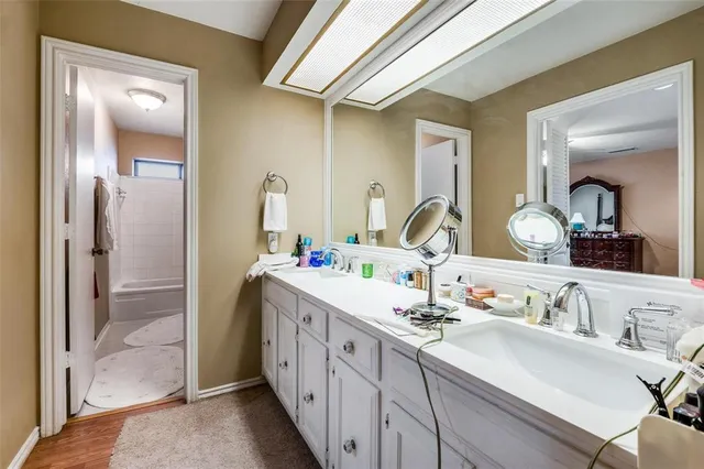 a bathroom with a double vanity sink and a mirror