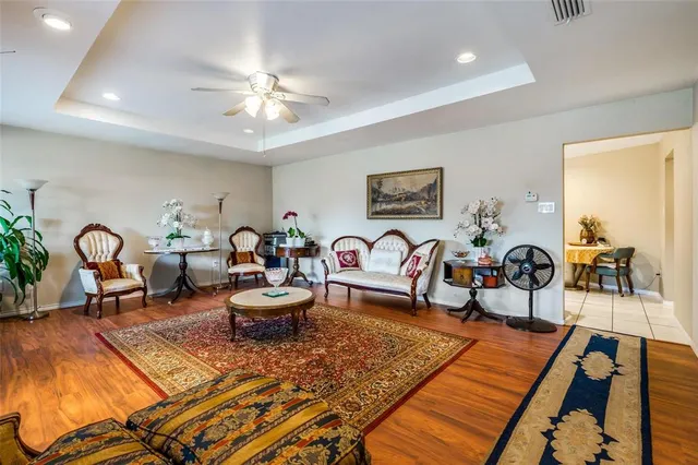 a living room with furniture and view of kitchen