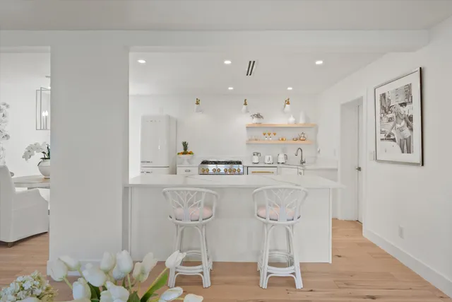 a kitchen with a stove top oven sink and cabinets