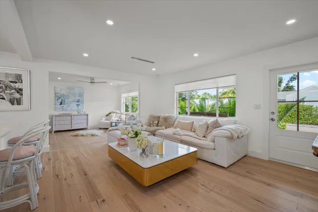 a living room with furniture and a painting on the wall