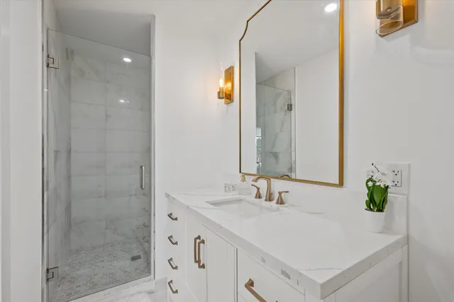 a spacious bedroom with a bed and a view of bathroom