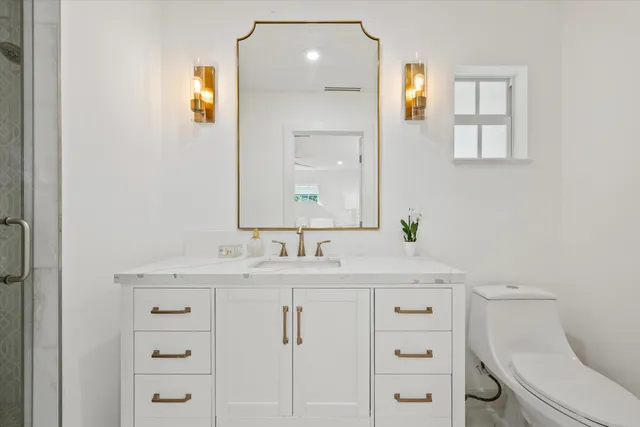 a bathroom with a sink toilet and shower