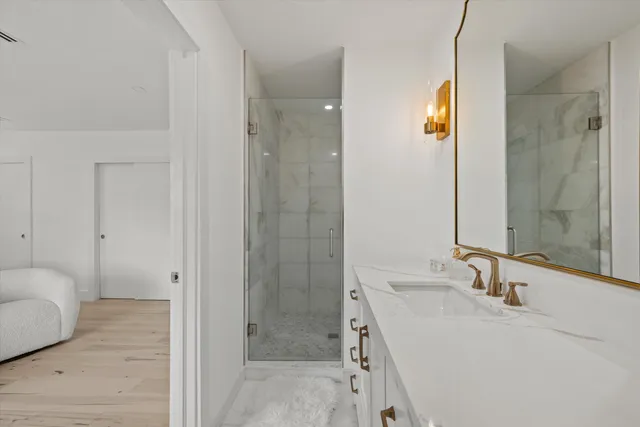 a bathroom with a sink toilet and shower