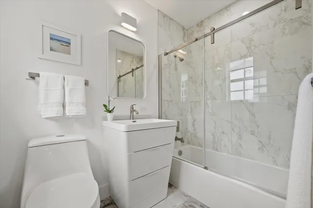 a front view of a house with a yard and potted plants