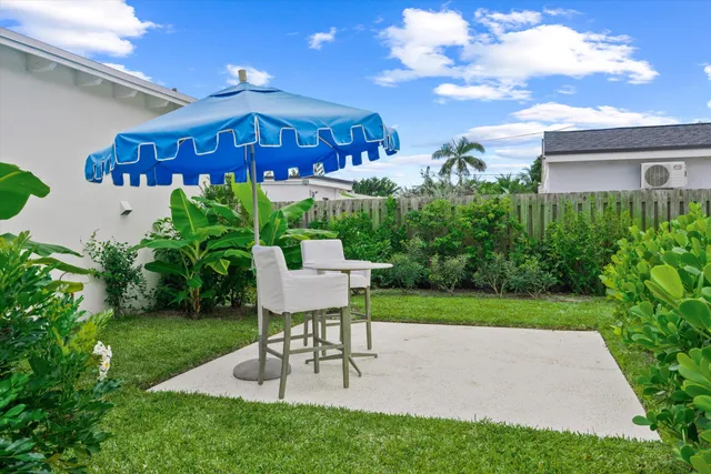 a front view of a house with a garden and yard