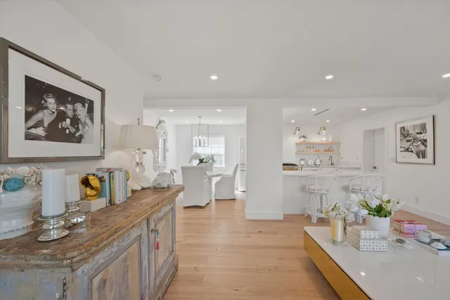 a large kitchen with stainless steel appliances a large counter top a stove and a refrigerator