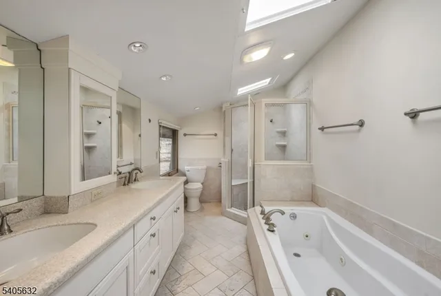 a bathroom with a granite countertop tub sink double vanity granite tub shower and mirror