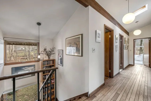 a view of a hallway with wooden floor and door