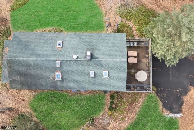 an aerial view of a house with a yard