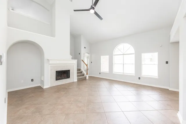 a view of empty room with a fireplace