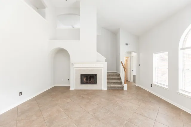 a view of empty room with a fireplace