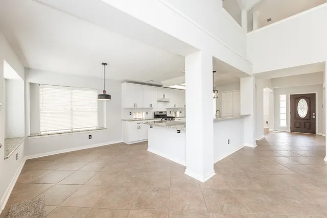 a kitchen with granite countertop white cabinets and white appliances