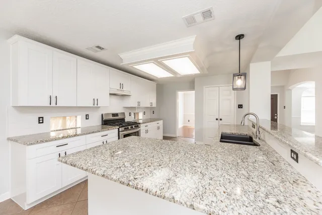 a large white kitchen with a white cabinets