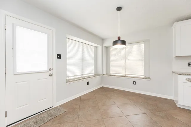 a spacious bathroom with a granite countertop sink mirror and shower