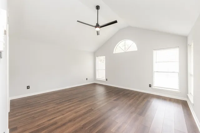 a spacious bathroom with a double vanity sink a mirror and a bathtub