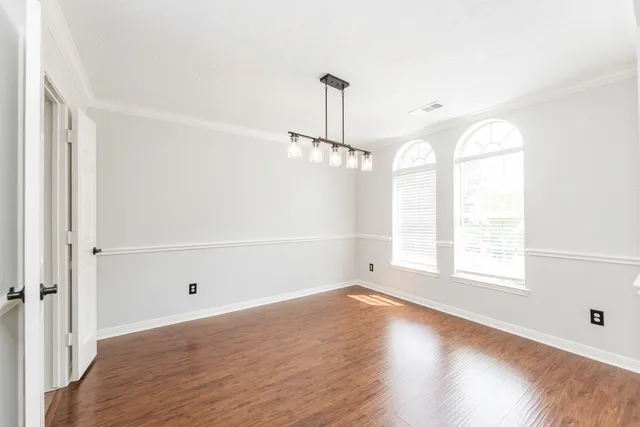 a view of an empty room with a fireplace and a window