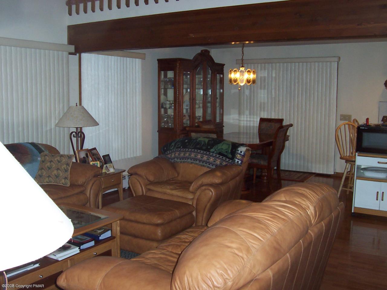 29 Hemlock Road Blakeslee, PA 18610 - Photo 4 of 7 a living room with furniture a lamp and a chandelier