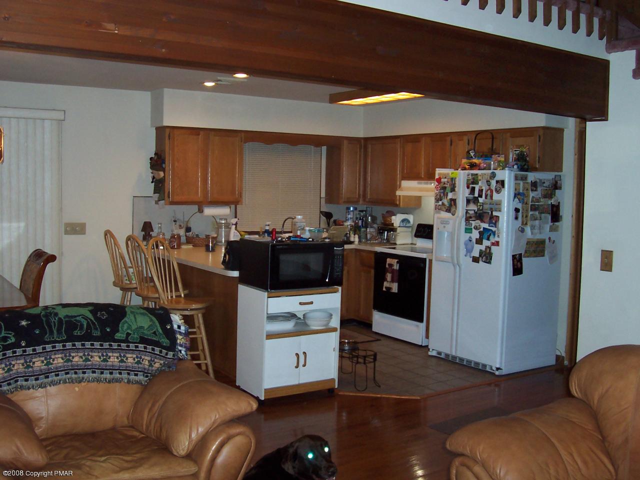 29 Hemlock Road Blakeslee, PA 18610 - Photo 5 of 7 a living room with furniture and a refrigerator