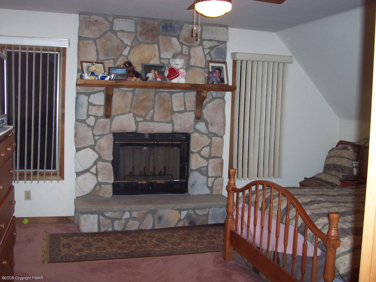 29 Hemlock Road Blakeslee, PA 18610 - Photo 6 of 7 a living room with fireplace furniture and a wooden floor