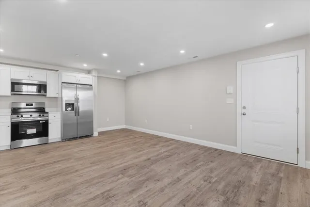 a view of a kitchen with a sink and a refrigerator
