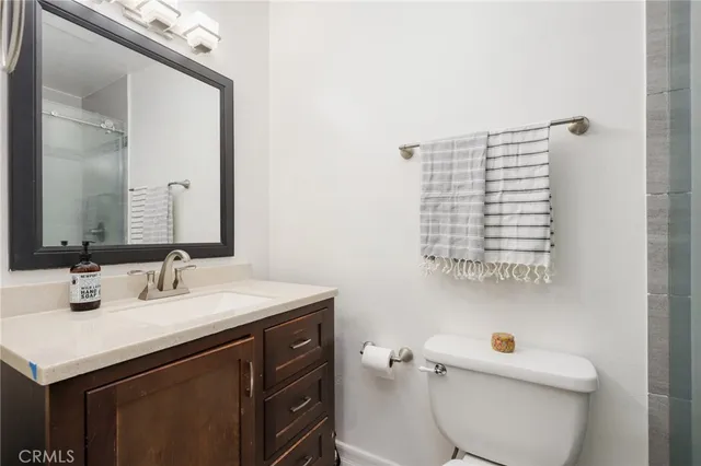 a bathroom with a sink vanity and a toilet