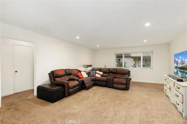 a living room with furniture window and a flat screen tv